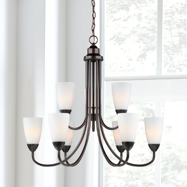 a group of candles on a black chain from a window